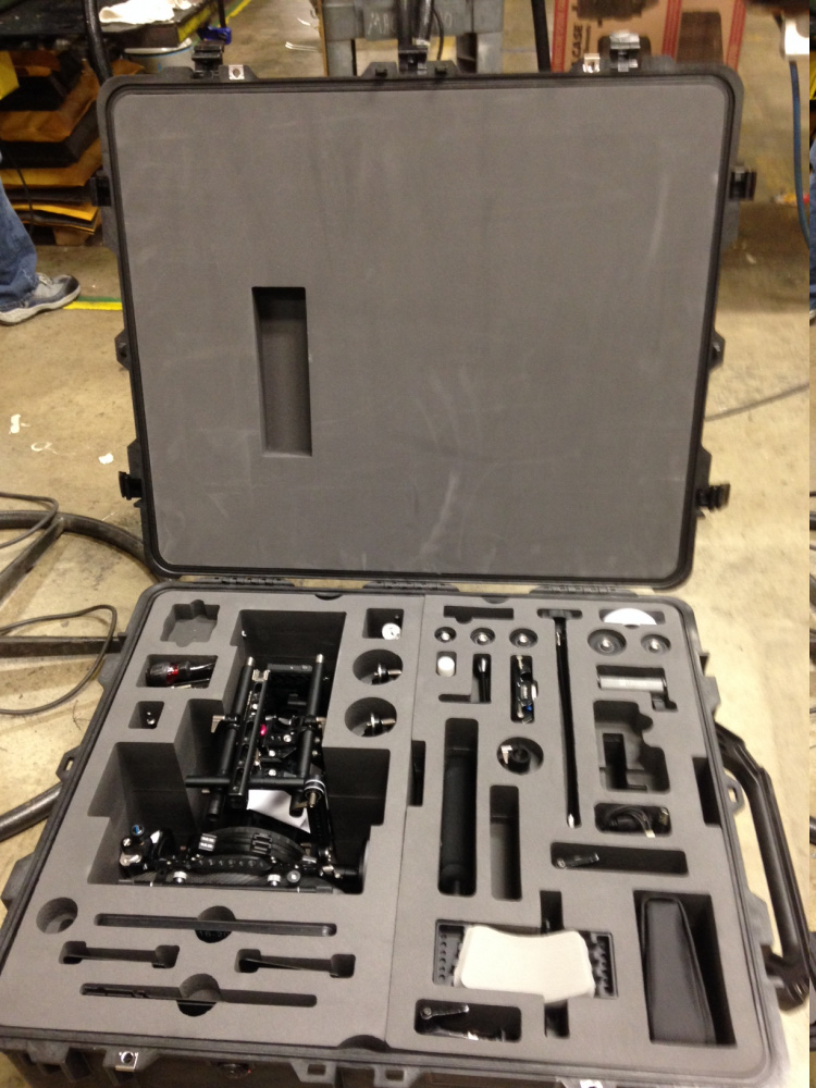 Heavy-duty carrying case with foam insert custom-made to hold various camera equipment and accessories.