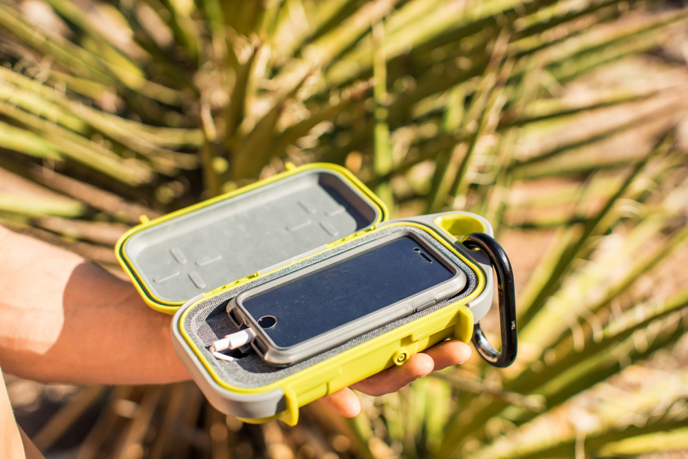 Pelican G40 Go Case open to display cell phone with charger that both fit inside the case.