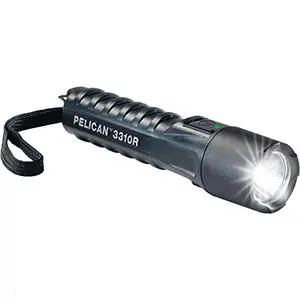 Black compact flashlight that is powered on.
