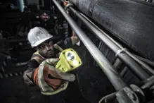 Industrial worker using a safety certified Pelican flashlight.